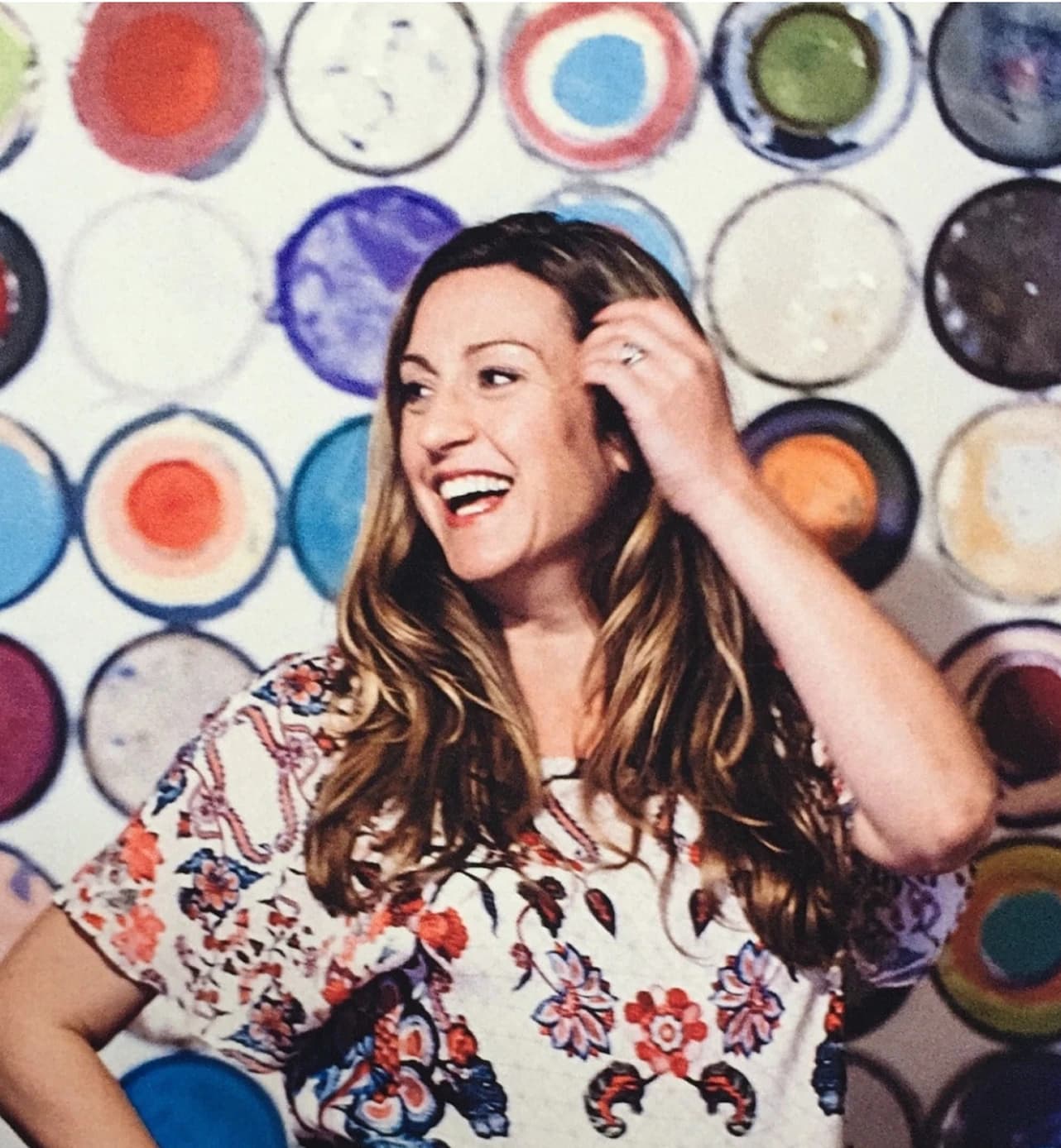 Meredith Mallwitz-Meyer smiling in front of colorful paint cans