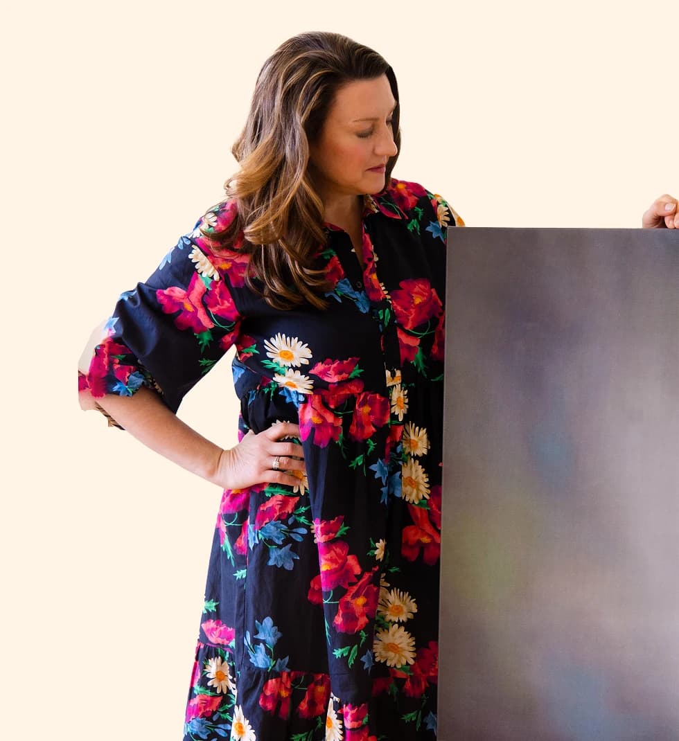 Meredith Mallwitz-Meyer holding a painted canvas